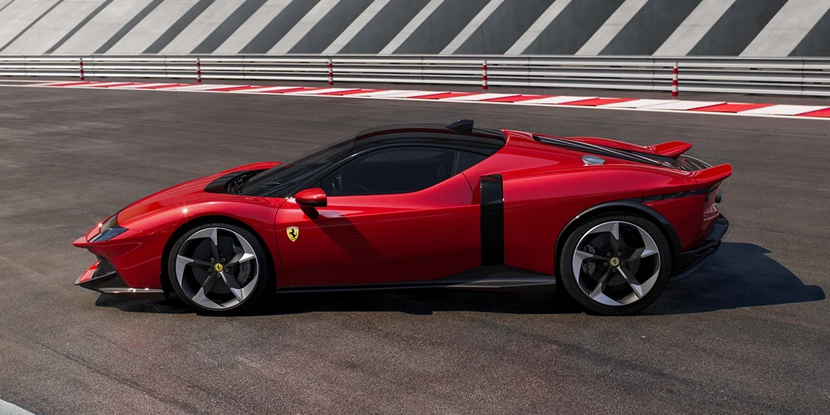Profile view of the Ferrari 849 Testarossa in red parked on track, showcasing its low stance and sporty side design.